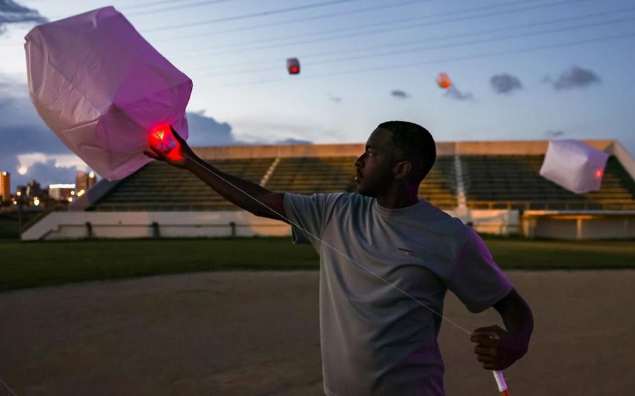 U.S. Marine Corps Sgt. Leonard Ayres, a dynamic component mechanic assigned to Marine Aviation Logistics Squadron 36, 1st Marine Aircraft Wing, holds a lantern during the Lanterns for Life Festival at Camp Foster, Okinawa.